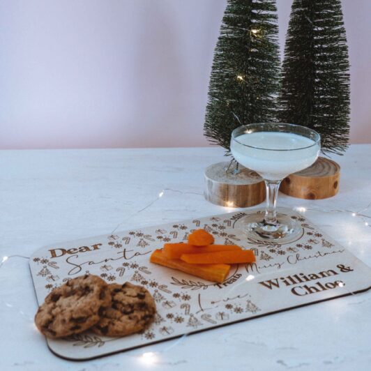 Milk and Cookies and Reindeer Treats on Santa Snack board with Christmas decorations